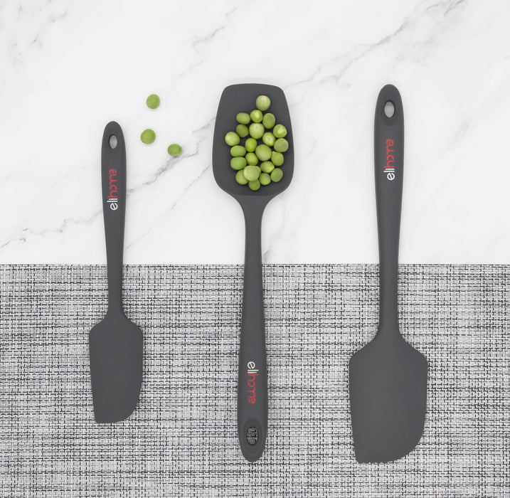 Elihome grey silicone spoonula holding green peas to demonstrate its scooping capability, shown with a mini spatula and classic spatula. The set features a minimalist grey design with red accents.