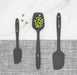 Elihome grey silicone spoonula holding green peas to demonstrate its scooping capability, shown with a mini spatula and classic spatula. The set features a minimalist grey design with red accents.