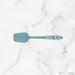 Blue spatula on a marble background