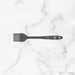 Black hairbrush with a brand logo on a marble background