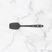 Black spatula on a white marble background