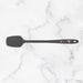 Black spatula on a white marble surface