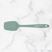 Green spatula with 'elihome' branding on a marble background