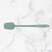 Green spatula on a marble background