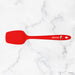Red spatula with a brand logo on a marble background