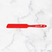 Red spatula with 'elithe' branding on a white marble background
