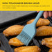 Blue silicone brush being used to baste chicken wings on a grill with text about brush head durability.