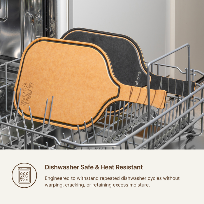 Elihome pickleball paddle cutting board standing in a dishwasher rack, dishwasher safe and heat resistant without warping