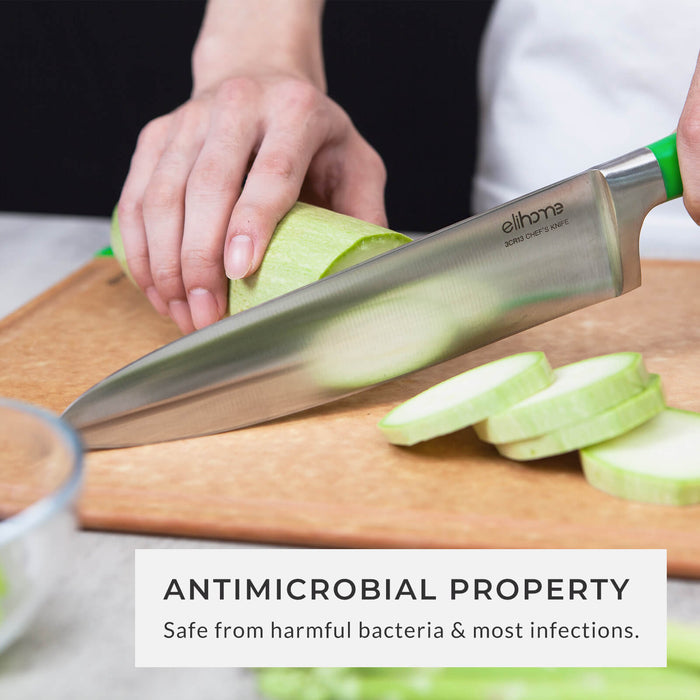 Hand slicing zucchini on an antimicrobial fiber wood cutting board, highlighting the non-porous surface that is safe from harmful bacteria and infections.